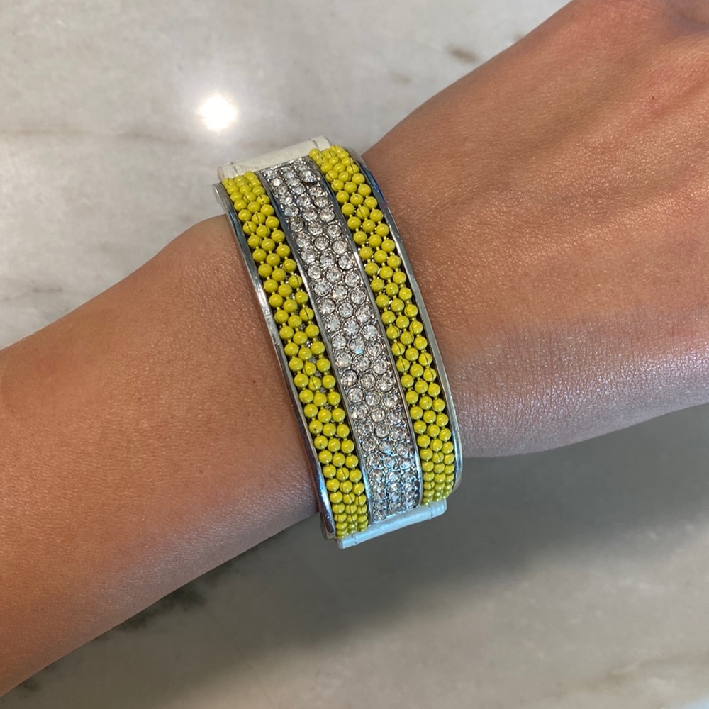 Bracelet with yellow beads and rhinestones.
